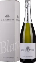 Flasche mit grünem Glas und silbernem Folienverschluss, neben einer beigen Box mit schwarzer und silberner Schrift und einem eleganten Design.