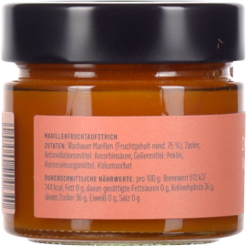 Kleines Glas mit orangefarbener Marillenfruchtaufstrich, schwarzer Deckel, rosa Etikett.