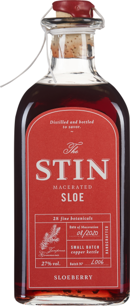 Elegante Flasche mit tiefroter Flüssigkeit und rotem Etikett; transparenter Korken und versiegelter Verschluss.