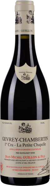 Weinflasche mit beigem Etikett, verziert mit feinen Illustrationen und rotem Text. Elegante, dunkle Flasche mit hellem, bedrucktem Hals und Siegel.