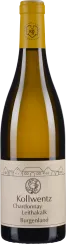 Die Weinflasche hat ein minimalistisches Etikett in Beige mit schwarzer Schrift und einem kleinen Emblem. Der Flaschenhals ist mit einer gelben Folie überzogen. Der Wein ist in einer klaren Glasflasche abgefüllt.