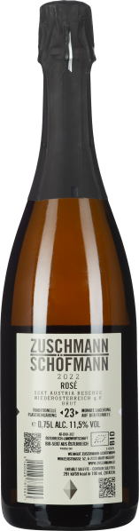 Sektflasche mit dunkelgrauer Kapsel, goldener Flüssigkeit und weißem Etikett.