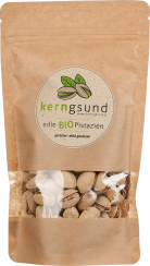 Nachhaltige braune Verpackung mit Sichtfenster, gefüllt mit Pistazien in der Schale. Runde Etikette mit grünen Details.