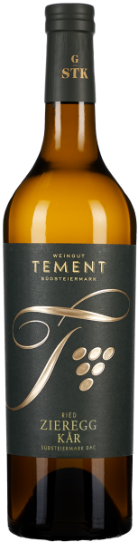 Die Weinflasche hat ein elegantes Design mit einem dunkelgrauen Etikett und goldener Schrift. Die Flasche selbst ist aus braunem Glas. Ein stilisiertes Traubenmotiv ziert das Etikett.