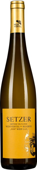 Braune Weinflasche mit einem goldfarbenen Schraubverschluss und einem leuchtend gelben Etikett, das schwarze und goldene Schrift sowie eine grafische Weinreben-Illustration zeigt.