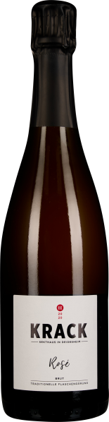 Dunkle Flasche mit schlichtem Etikett, schwarzer Kapsel, roséfarbener Schaumwein.