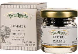 Ein Glas mit goldfarbenem Deckel gefüllt mit Sommertrüffeln, daneben eine dekorative Verpackung mit Baumillustration und eleganten Schriftzügen.