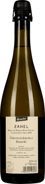 Braun-grüne Sektflasche mit cremefarbenem Etikett, schwarzem Hals und Korkverschluss.