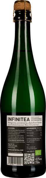 Grüne Flasche mit Korkverschluss und schwarzem Etikett.