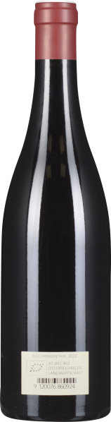 Weinflasche mit rotem Verschluss und dunklem, glänzendem Glas.