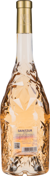 Facettierte Flasche mit blassrosa Wein und goldener Kapsel.