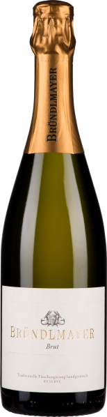 Die Weinflasche ist elegant gestaltet mit einem goldenen Folienverschluss und einem klaren Etikett. Der Flaschenkörper ist dunkel und hat eine klassische Form, mit einer breiten Basis und schlankerem Hals.