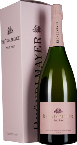 Flasche Bründlmayer Brut Rosé neben einer passenden, hellrosa Geschenkverpackung, elegant gestaltet mit einem goldenen Logo und Schriftzug auf dem Etikett.