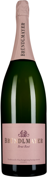 Grüne Sektflasche mit elegantem, rosafarbenem Etikett und passendem Flaschenhals. Das Etikett weist goldene Schrift auf und zeigt ein stilisiertes Logo.