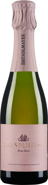 Die Flasche zeigt einen Schaumwein mit einem blassrosa Etikett und einer passenden metallischen Folie am Hals. Die Form ist elegant und klassisch, passend für einen hochwertigen Sekt oder Champagner.
