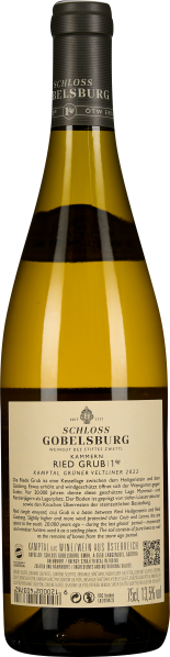 Schlanke Weinflasche mit gelblichem Inhalt und edlem, schwarzen Etikett oben.