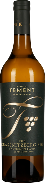 Braune Weinflasche mit dunkelgrünem Etikett; darauf goldene Schrift und grafisches Design mit stilisiertem "T" und Traubenmotiv.