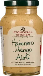 Glas mit helloranger Sauce mit leicht körniger Textur, dunkelgrüner Deckel, dezentes Etikett mit schwarzer Schrift.