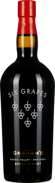 Dunkle Weinflasche mit rotem Halsabschluß, schlichtem Etikett und dekorativen Traubensymbolen auf der Vorderseite.