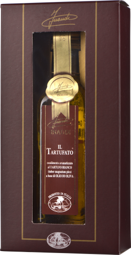 Braune Verpackung mit Sichtfenster, durch das eine Flasche mit goldener Kapsel sichtbar ist. Die Flasche enthält eine dunkel etikettierte Flüssigkeit, die hochwertig wirkt. Elegantes Design mit goldenen Details.