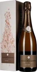 Flasche Champagner mit goldener Folie auf dem Korken und elegantem Etikett. Die Verpackung zeigt ein zartes Blumenmotiv in sanften Rosa- und Beigetönen.