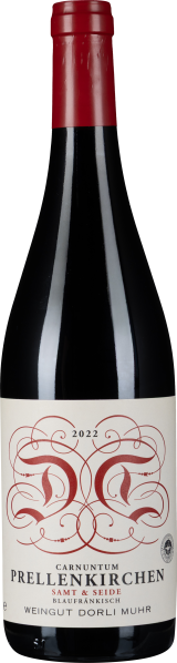 Eine Weinflasche mit rotem Kapselverschluss und elegantem Etikett. Das Etikett zeigt kunstvolle, rote Verzierungen auf einem cremefarbenen Hintergrund.