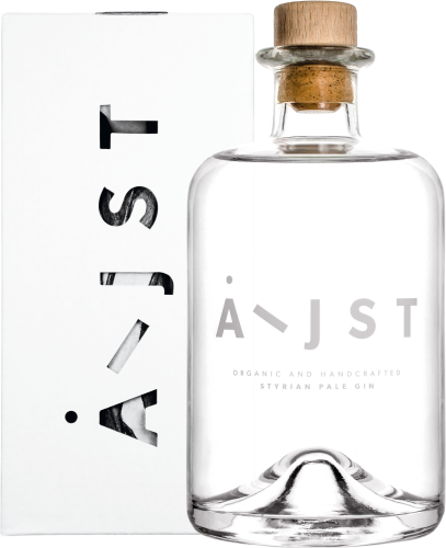 Klar gestaltete Glasflasche mit breitem Holzverschluss; minimalistisches Design auf einer weißen Schachtel mit moderner Typografie.