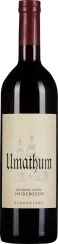 Dunkle Weinflasche mit bordeauxrotem Korken, großer beiger Etikett mit schwarzem und rotem Schriftzug sowie gezeichneter Kirchenabbildung.