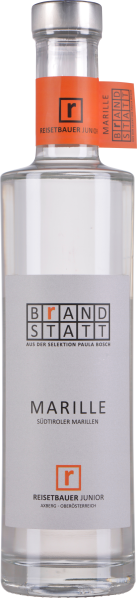 Klare Glasflasche mit silbernem Verschluss, schlichtem grauen Etikett mit schwarzer und oranger Schrift, und orangefarbenem Flaschenhalsband mit schwarzem Logo.