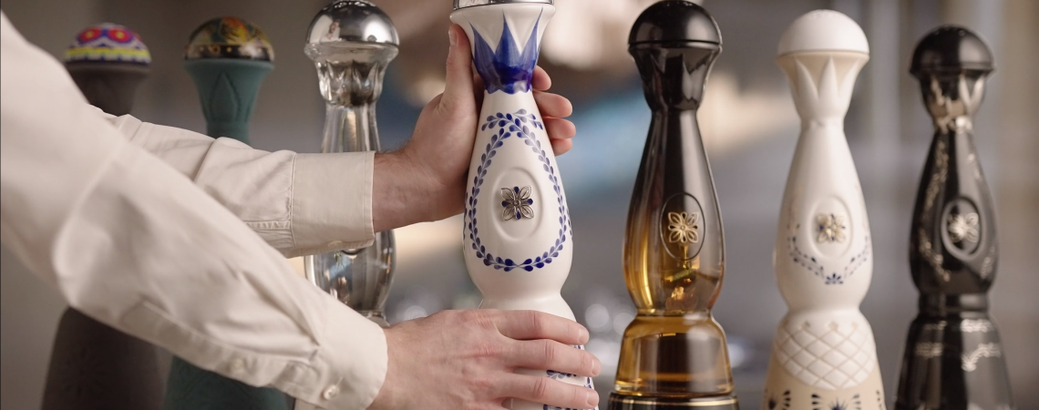 Verschiedene elegante Keramikflaschen in Weiß, Schwarz und Bernstein auf einem Tisch.