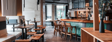 Moderne Bar mit Holzmöbeln, Glasdetails und stilvoller Beleuchtung.